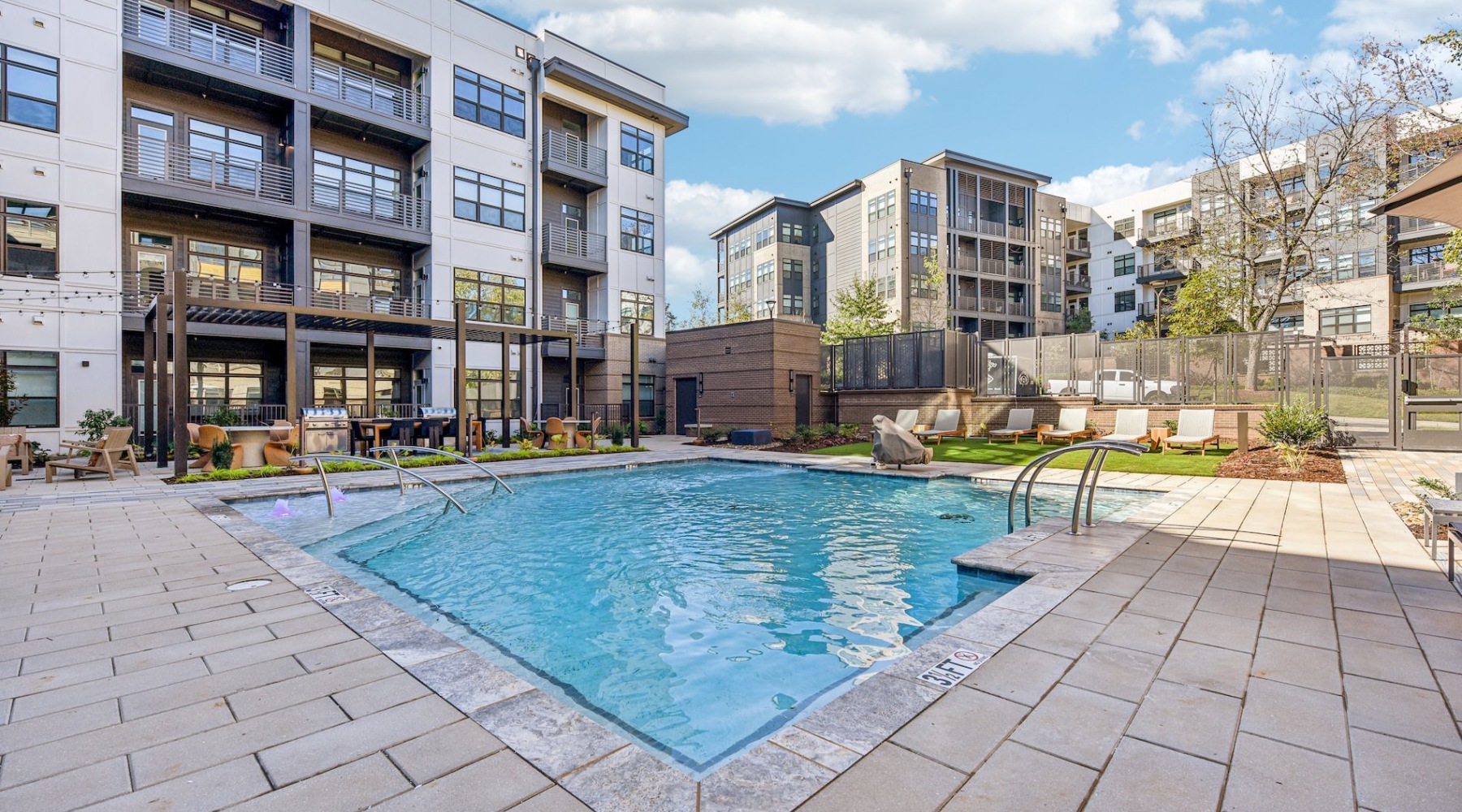Resort-style swimming pool with lounge seating