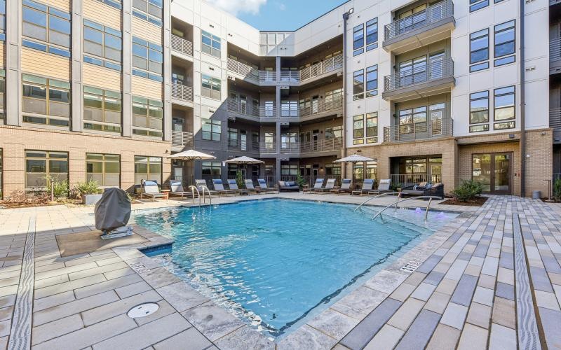 a swimming pool in a courtyard between buildings