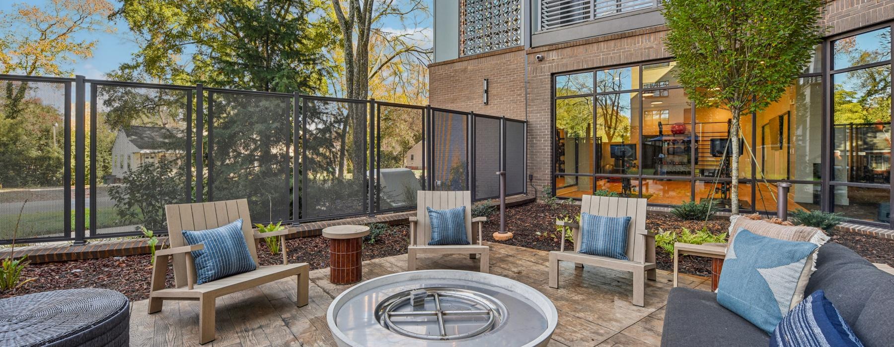 a patio with a pool and chairs